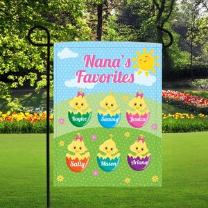 May include: A blue and green garden flag with the text "Nana's Favorites" and a smiling sun. Six chicks in eggshells with names are arranged in a circle on the flag.