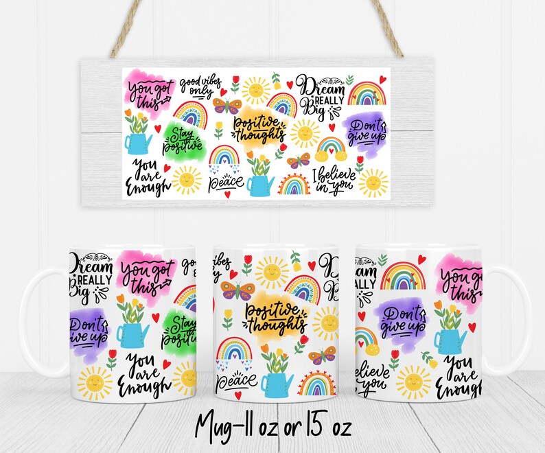 May include: Set of four 11 oz or 15 oz white ceramic mugs with colorful designs. Each mug features a different inspirational quote and colorful illustrations, including rainbows, butterflies, and suns. The quotes include "You got this", "Stay positive", "Dream really big", and "I believe in you".