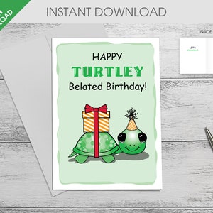 May include: A green turtle wearing a party hat carries a gift box with a red bow. The card reads "Happy Turtley Belated Birthday!"
