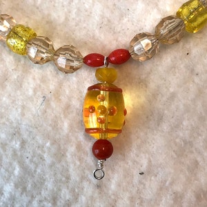 22-1. SALE! This short summer necklace is sunny and cheerful with orange and yellow beads, accented with red! Was 15 dollars, now 10.