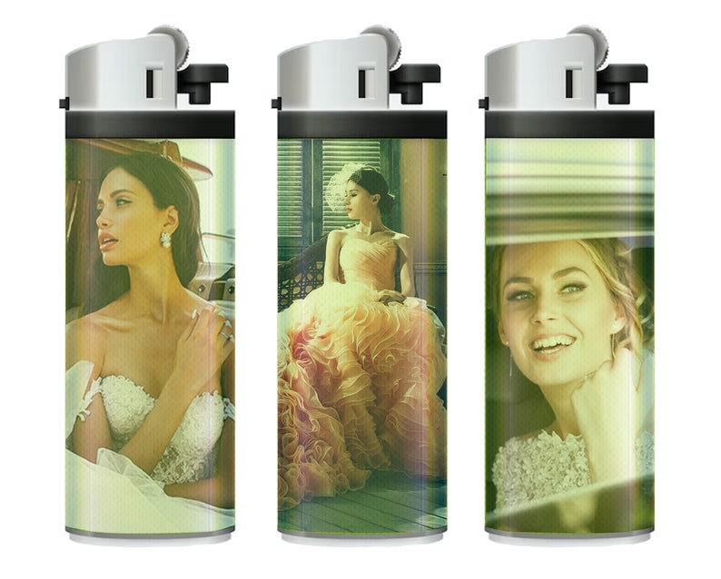 May include: Three silver lighters with different images of women in wedding dresses. The lighters are all the same size and shape, and they have a black plastic base.