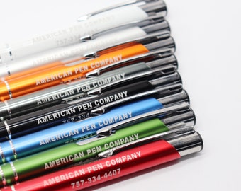 May include: A stack of ten pens in various colors, including white, orange, gray, black, blue, green, and red. Each pen has the text "AMERICAN PEN COMPANY" and a phone number engraved on the side.