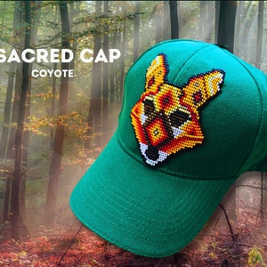 May include: A green baseball cap with a beaded coyote design on the front. The text "SACRED CAP COYOTE" is printed on the cap.