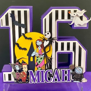 May include: A layered, purple and white striped "16" birthday decoration featuring characters from "The Nightmare Before Christmas." Includes Jack Skellington, Sally, Zero, and the name "Micah."