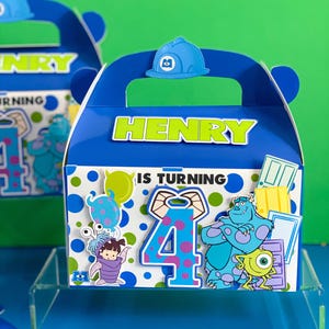 May include: Blue party favor box with a handle, featuring the name "HENRY" in green letters. The box is decorated with characters from the movie Monsters, Inc., the number 4, and the phrase "IS TURNING". A blue hard hat is on top.