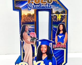 May include: A blue 3D number ten display featuring the text 2026 Graduate and DeArius. It includes three photographs of a person in a graduation cap and gown, a formal dress with flowers, and a blue athletic uniform with the Lamar University logo.