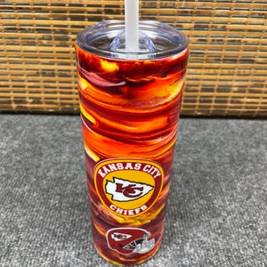 May include: A red and yellow stainless steel tumbler with a Kansas City Chiefs logo. The tumbler has a clear lid and a straw.