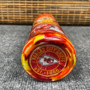 May include: A red, yellow and white stainless steel tumbler with a Kansas City Chiefs logo and the text "Kansas City Chiefs est. 1960".