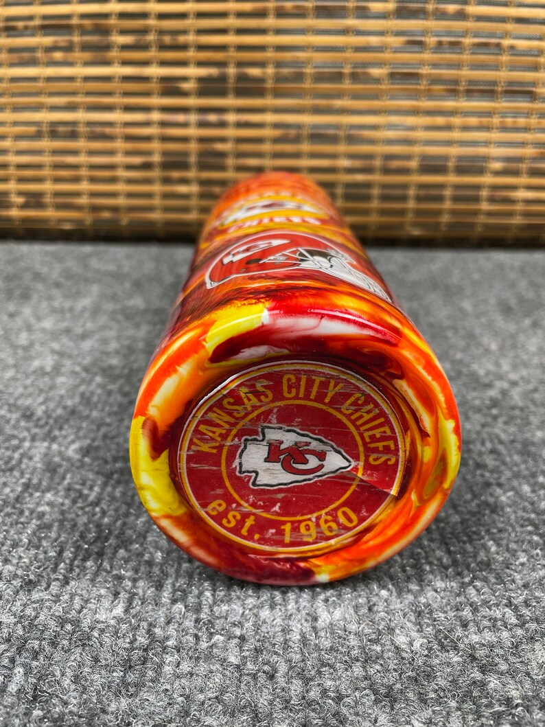 May include: A red, yellow and white stainless steel tumbler with a Kansas City Chiefs logo and the text "Kansas City Chiefs est. 1960".