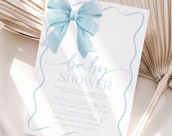 May include: A baby shower invitation with a light blue bow on a white background. The invitation has a white border and the text "baby shower" in cursive. The text on the invitation reads "Please join us for a baby shower celebrating the arrival of our little one."  Rebecca & Oliver Saturday, August 26th at 2:00 PM  [Address]  RSVP to [Phone Number] by August 19th