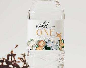 Op de afbeelding: Waterfleslabel met een jungledieren thema. Het label zegt "wild one" in gouden letters met de tekst "Oliver's 1st Birthday" eronder. Het label toont verschillende jungledieren, waaronder een leeuw, een giraffe, een olifant en een zebra.