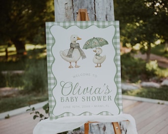 May include: A rectangular baby shower welcome sign featuring a green and white gingham border. The center displays two illustrated ducks, one wearing a scarf and one holding a green umbrella. Text reads: Welcome to Olivia's Baby Shower, June 10th, 20XX, Miami, FL.