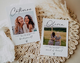 May include: Two cards with photos of two women each. The text on the cards reads "I can't say 'I do' without you! Will you be my bridesmaid?" and "I can't say 'I do' without you! Will you be my maid of honor?"