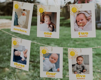 May include: A set of six white cards with photos of a baby at different ages, from newborn to five months. Each card has a yellow sun with rays and the age of the baby in months written below the photo.