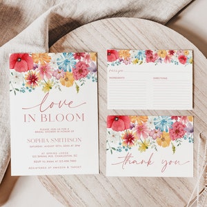 May include: A floral bridal shower invitation with the text "love in bloom" and the bride's name "Sophia Smithson". The invitation includes the date, time, and location of the shower. A recipe card and a thank you card are also included, both with floral designs.
