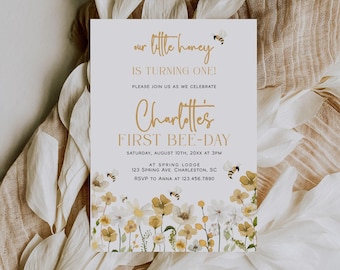 May include: A rectangular invitation card featuring a white background with watercolor illustrations of yellow and white wildflowers and small bees. The text reads: our little honey IS TURNING ONE! PLEASE JOIN US AS WE CELEBRATE Charlotte's FIRST BEE-DAY.