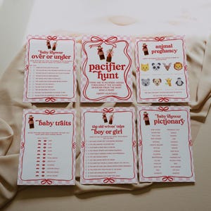 May include: A set of six pink and white baby shower game cards. The cards feature various games, including "Pacifier Hunt" and "Animal Pregnancy." Each card has a decorative border and playful illustrations, perfect for a baby shower.