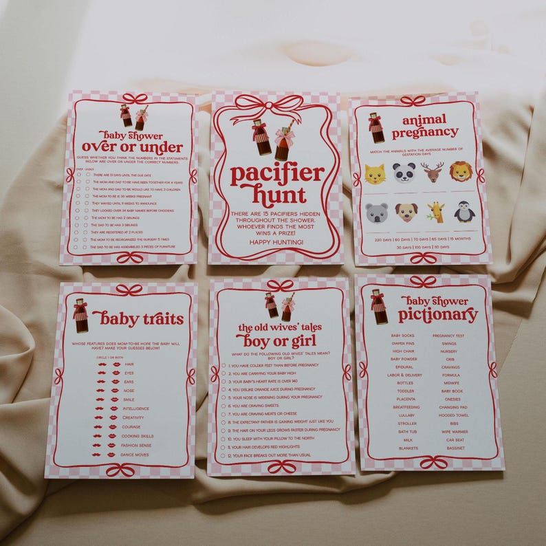 May include: A set of six pink and white baby shower game cards. The cards feature various games, including "Pacifier Hunt" and "Animal Pregnancy." Each card has a decorative border and playful illustrations, perfect for a baby shower.