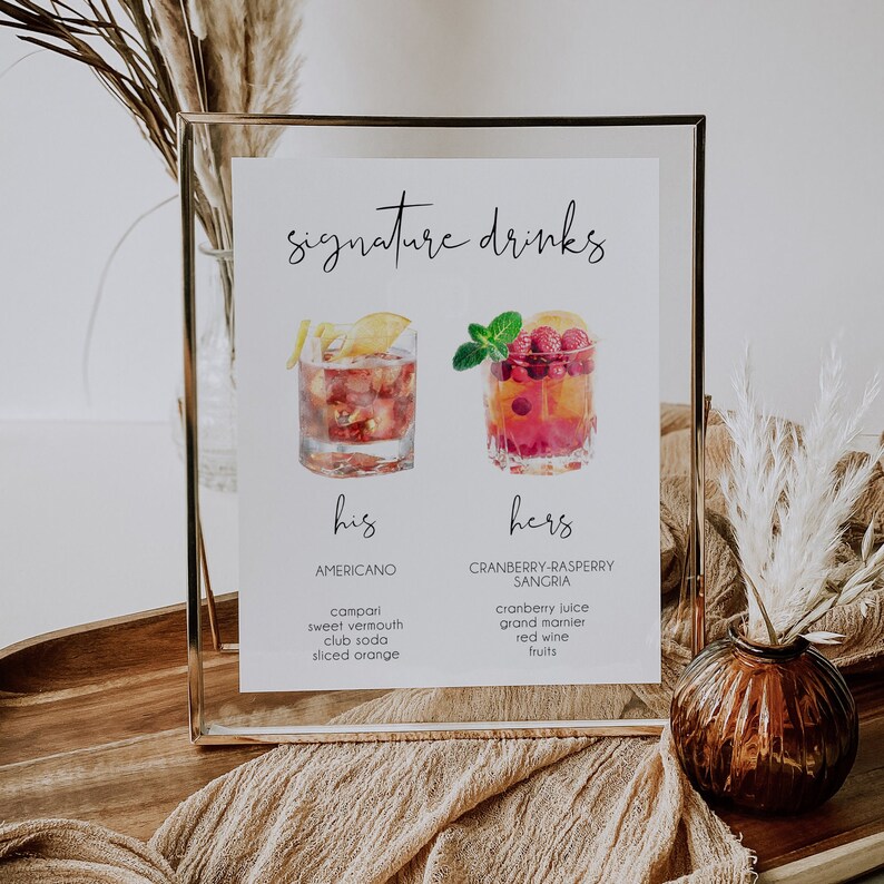 May include: A printable sign with the text "signature drinks" and two watercolor illustrations of cocktails. The left cocktail is labeled "his" and "Americano" with ingredients listed below. The right cocktail is labeled "hers" and "Cranberry-Raspberry Sangria" with ingredients listed below.