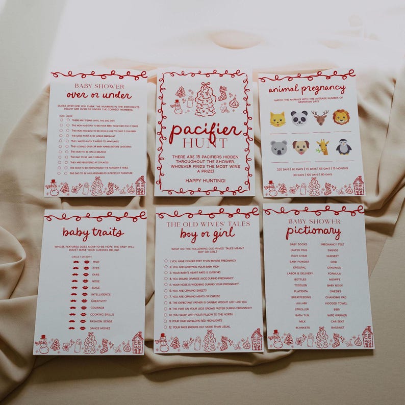 May include: Six baby shower game cards with red text and illustrations on a cream background. Games include "Over or Under," "Pacifier Hunt," "Animal Pregnancy," "Baby Traits," "Boy or Girl," and "Baby Shower Pictionary."