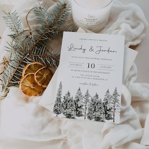 Puede incluir: Invitaci&oacute;n de boda con una ilustraci&oacute;n de acuarela en blanco y negro de un bosque nevado. La invitaci&oacute;n dice "Lindy & Jordan" e incluye la fecha "S&aacute;bado, 10 de enero".