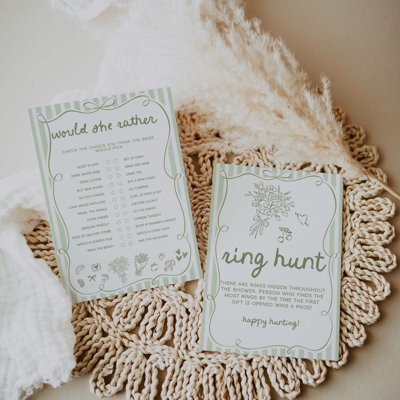 May include: Two light green and white striped cards with text for a bridal shower game. One card says "Would she rather" with a list of choices. The other card says "ring hunt" with instructions. Both cards have floral illustrations.