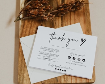 May include: A white thank you card with black text. The card says "Thank you" with a heart symbol. It also includes a discount code "THANKYOU15" and social media icons with the text "let's be social!" and "@YOURUSERNAME" and "WWW.YOURWEBSITE.COM".