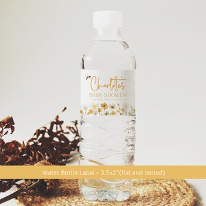 May include: Water bottle label with a floral design and a bee. The label says "Charlotte's Baby Shower" with the date and location. The label is 3.5 inches by 2 inches and is designed to be flat or tented.