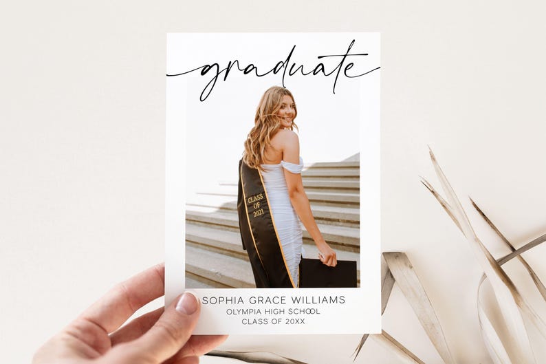 May include: A graduation announcement card with a photo of a person wearing a white dress and a black graduation gown. The text on the card reads "graduate", "Sophia Grace Williams", "Olympia High School", and "Class of 20XX".