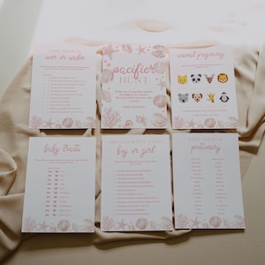 May include: Six rectangular baby shower game cards with a light pink seashell and coral border. The cards feature titles including Baby Shower Over or Under, Pacifier Hunt, Animal Pregnancy, Baby Traits, The Old Wives Tales Boy or Girl, and Pictionary.