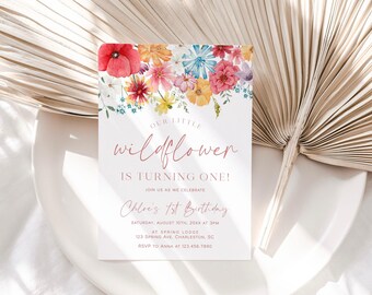May include: A rectangular birthday invitation card featuring a watercolor floral arrangement in red, orange, pink, and blue at the top. The text reads: Our little wildflower is turning one! Join us as we celebrate Chloe's 1st Birthday, Saturday, August 10th, 20XX at 3pm, at Spring Lodge, 123 Spring Ave, Charleston, SC, RSVP to Anna at 123.456.7890.