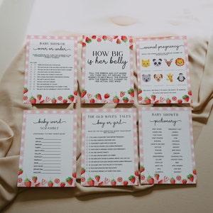 Peut inclure: Un ensemble de cartes de jeu de baby shower imprimables sur le th&egrave;me de la fraise. Les jeux comprennent "Plus ou moins", "Quelle est la taille de son ventre", "Grossesse animale", "M&eacute;lange de mots pour b&eacute;b&eacute;", "Les vieilles femmes disent : gar&ccedil;on ou fille", et "Pictionary de baby shower".