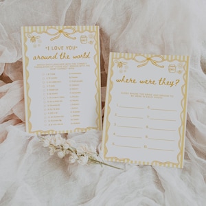 May include: Two wedding game cards with yellow and white striped borders. One card says "I LOVE YOU" around the world, with a matching game. The other card says "where were they?" with numbered lines for answers. Both cards have bee and honey pot illustrations.