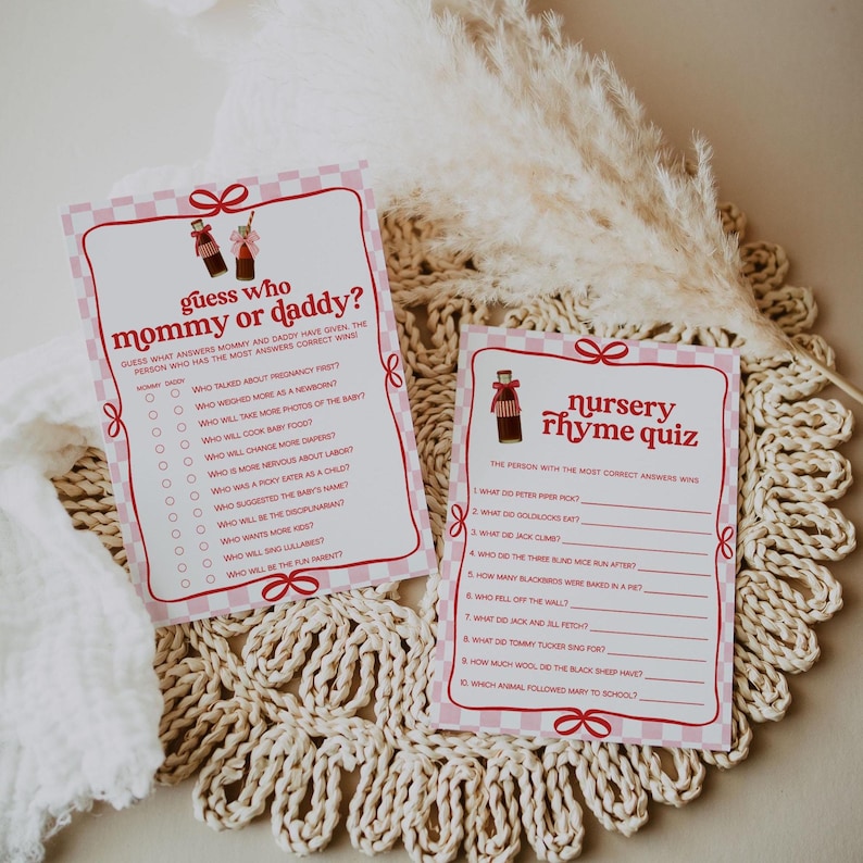 May include: Two pink baby shower game cards with a gingham border and bow accents. One card reads "Guess Who Mommy or Daddy?" and the other "Nursery Rhyme Quiz." Both cards feature a vintage soda bottle graphic.