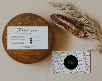 May include: A thank you card with a black and white design. The card has the text "Thank you for your purchase!" and a space for a logo. The card is on a wooden surface with dried grass.