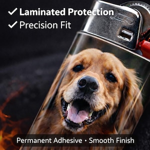 May include: A lighter with a smiling golden retriever dog image. The lighter has the text "Laminated Protection", "Precision Fit", "Permanent Adhesive", and "Smooth Finish". The lighter is silver and black.