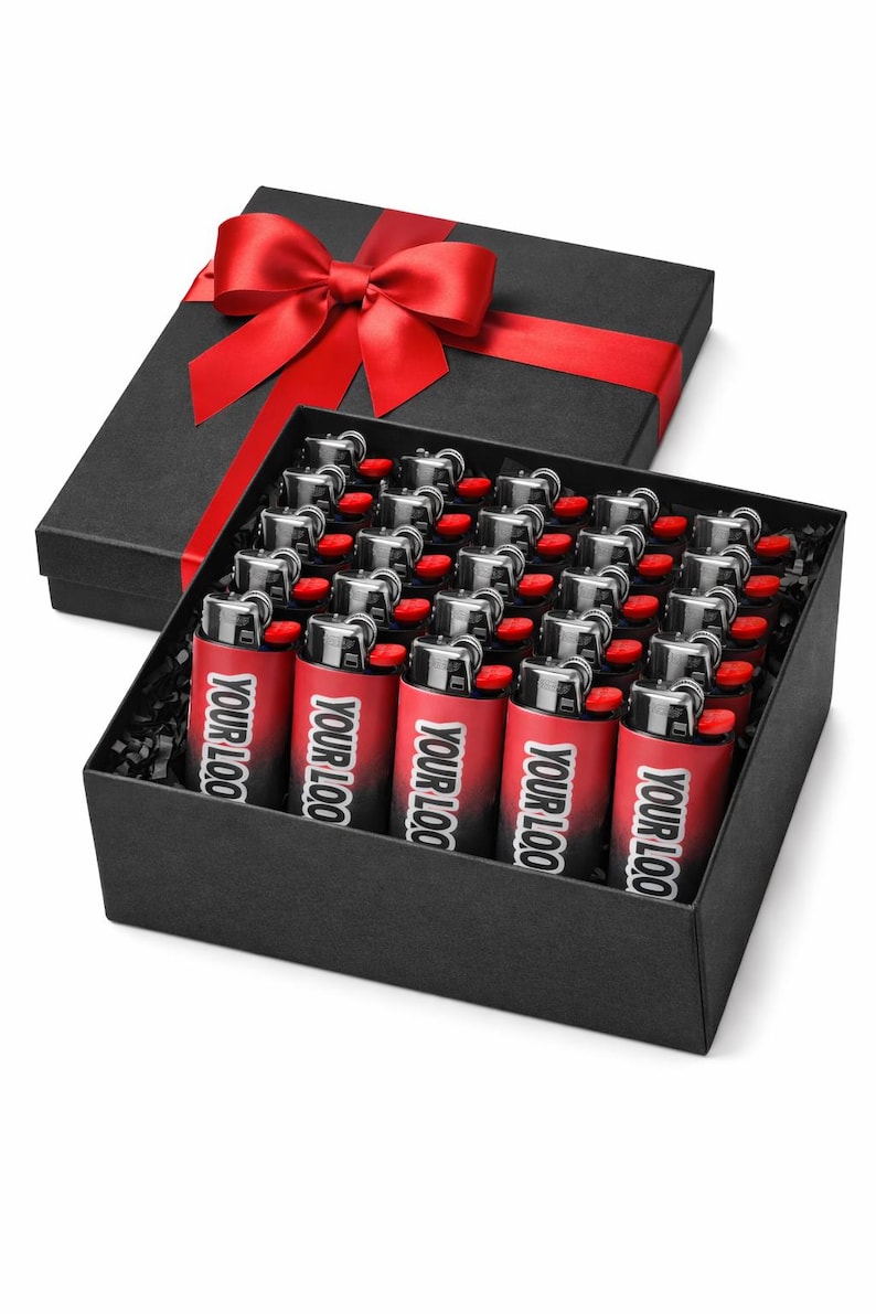 May include: A black gift box with a red satin bow contains a tray of red and black lighters. Each lighter has the text "YOUR LOO" printed on it. The box is on a white background.