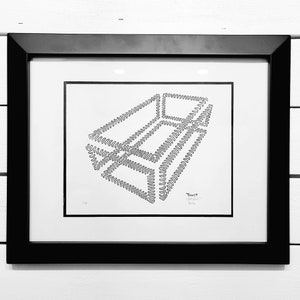 May include: A black and white framed print of a geometric design with the word "Twist" written in the bottom right corner.