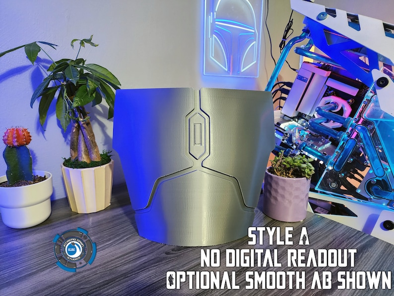 May include: A silver 3D printed chest piece with a smooth finish. The chest piece has a rectangular shape with a raised, rectangular panel in the center. The text "STYLE A NO DIGITAL READOUT OPTIONAL SMOOTH AB SHOWN" is below the chest piece.