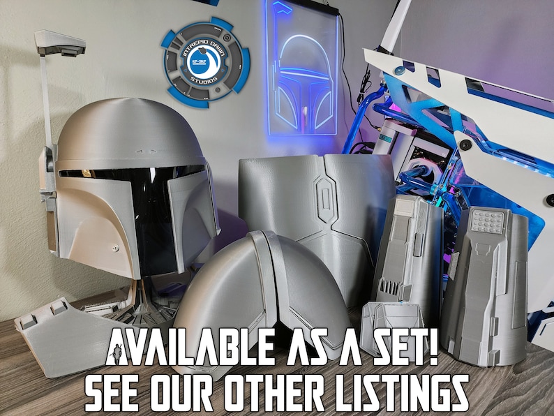 May include: A set of 3D printed Mandalorian armor pieces, including a helmet, chest plate, and two arm pieces. The pieces are a silver color and are displayed on a wooden surface. The text "AVAILABLE AS A SET! SEE OUR OTHER LISTINGS" is visible in the image.