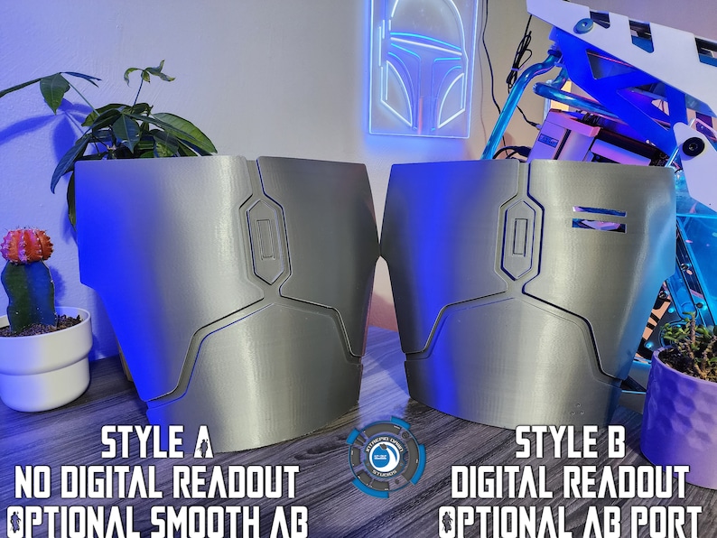 May include: Two 3D printed silver-colored armor pieces with different styles. The piece on the left has a smooth surface and the text "STYLE A NO DIGITAL READOUT OPTIONAL SMOOTH AB". The piece on the right has a digital readout and the text "STYLE B DIGITAL READOUT OPTIONAL AB PORT".