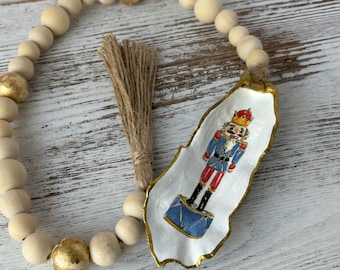 Nutcracker Oyster Shell Garland: Decoupaged Christmas Ornament with Wood Beads