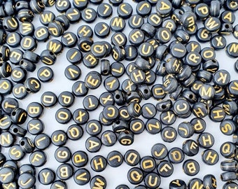 Black and gold acrylic letter beads.