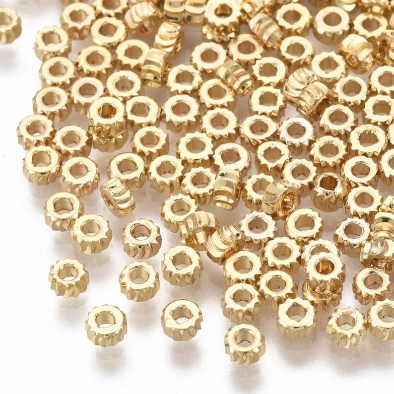 Perles rondelles torsion en plaqué or 18k. 4mm. Lot de 10. image 1