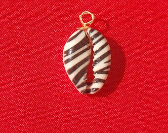 Natural zebra shell pendants, with 18k gold plated fastener. Sold individually.