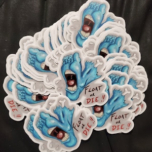 May include: A stack of blue and white stickers featuring a cartoon foot with the text "Float or Die!" in red. The foot is open-mouthed and has a bone sticking out of it.