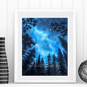 May include: A framed watercolor painting of a night sky with a bright blue and white galaxy. Silhouetted trees frame the bottom and sides of the image. The artist's signature, "AidaTrifidyArt", is visible in the lower right corner.