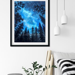 May include: A framed watercolor painting of a starry night sky, with silhouetted pine trees in the foreground. The artwork features a vibrant blue and white galaxy, a shooting star, and the text "AidaTurkkyArt". The frame is black.