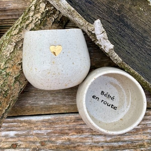 Golden heart mug announces pregnancy "baby on the way"
