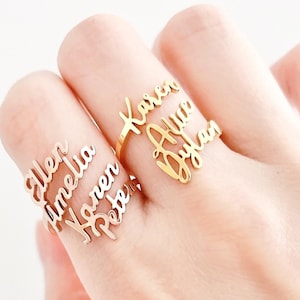 May include: Gold ring with multiple names engraved on it, including "Karen", "Allen", "Amelia", "Peter", and "Dylan".